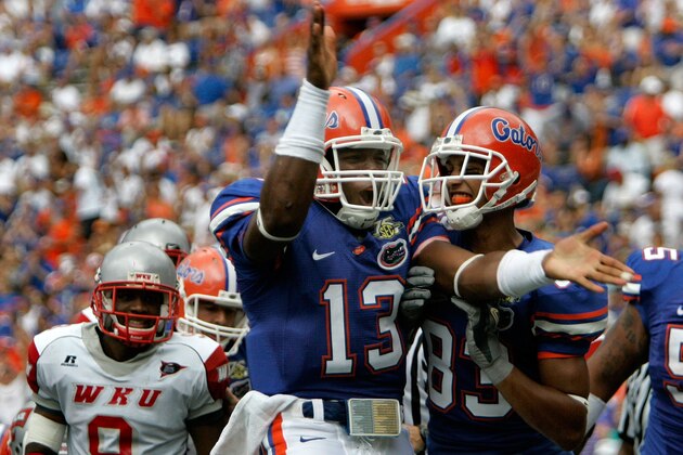 Western Kentucky's Rashad Etheridge (9) watches as Florida quarterback Cameron Newton (13) celebrates with teammate David Nelson, right, after scoring a touchdown on a four yard run, during the second half a college football game in Gainesville, Fla., Saturday, Sept. 1, 2007.(AP Photo/John Raoux)