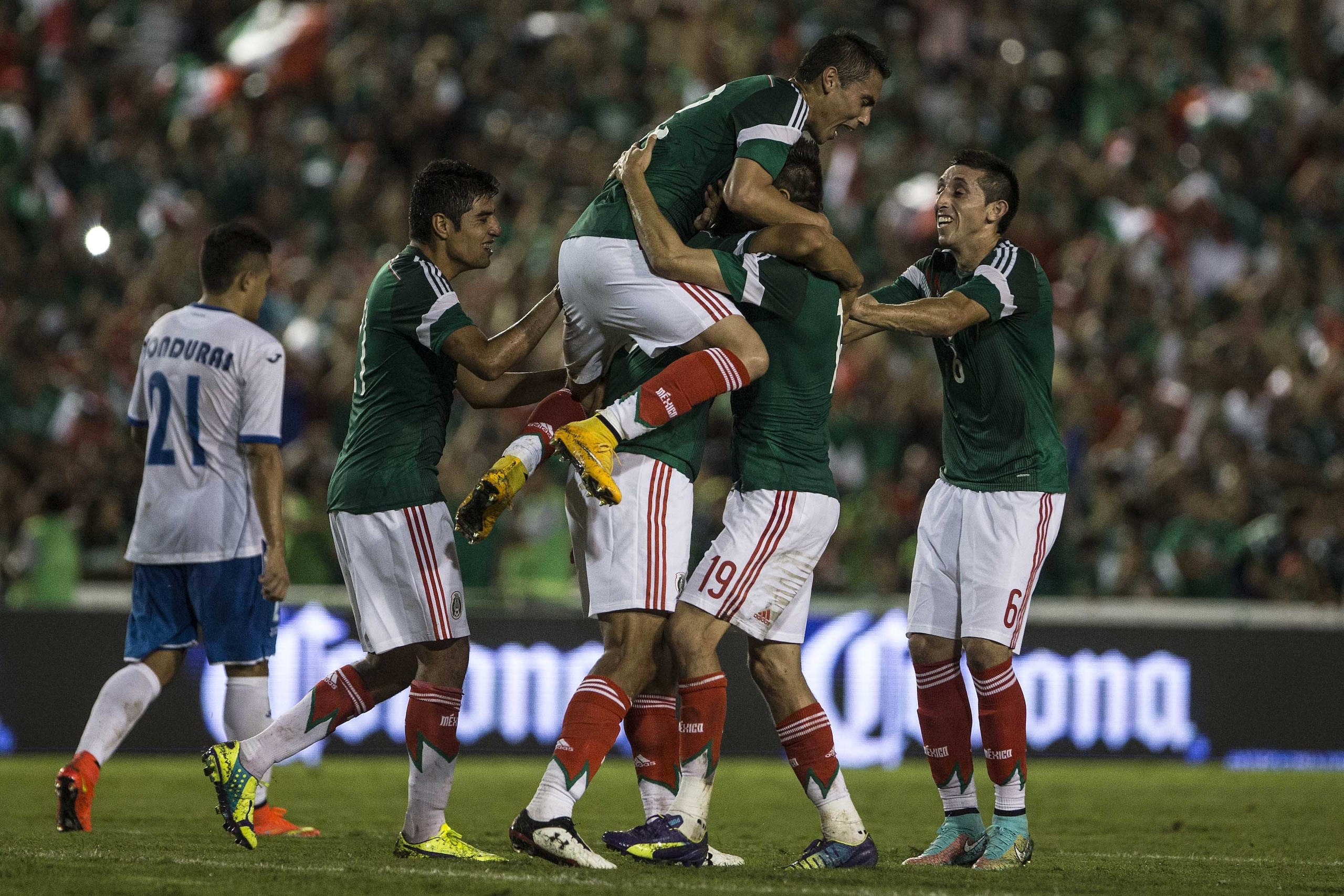 Mexico's Oswaldo Alanis celebrates with teammates after scoring against Honduras during a friendly soccer match, in Tuxtla Gutierrez, Thursday, Oct.  9, 2014. (AP Photo/Christian Palma)