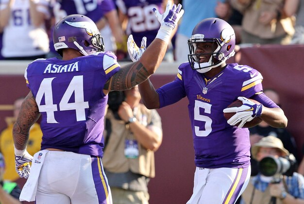 Sep 28, 2014; Minneapolis, MN, USA; Minnesota Vikings quarterback Teddy Bridgewater (5) celebrates his touchdown with running back Matt Asiata (44) during the second quarter against the Atlanta Falcons at TCF Bank Stadium. Mandatory Credit: Brace Hemmelgarn-USA TODAY Sports