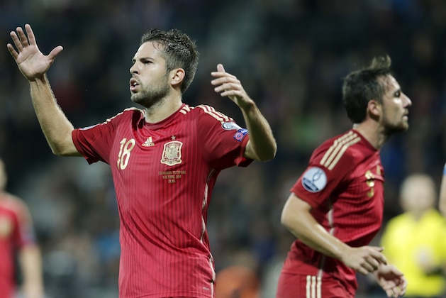 Spain's Jordi Alba, left, and Paco Alcacer, right, react during the Group C Euro 2016 qualifying match between Slovakia and Spain in Zilina, Slovakia, Thursday, Oct. 9, 2014. (AP Photo/Petr David Josek)
