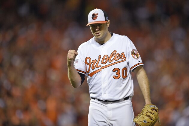 Baltimore Orioles starting pitcher Chris Tillman (30) pumps his fist as he walks off the mound in the fifth inning against the Detroit Tigers during Game 1 of baseball's AL Division Series, Thursday, Oct. 2, 2014, in Baltimore. (AP Photo/Nick Wass)
