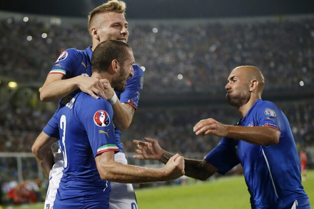 Italy’s Giorgio Chiellini, bottom left, celebrates with his teammates Ciro Immobile, top left, and Simone Zaza after scoring during the Euro 2016 qualifying soccer match between Italy and Azerbaijan, at the La Favorita stadium, in Palermo, Italy, Friday, Oct. 10, 2014. (AP Photo/Antonio Calanni)