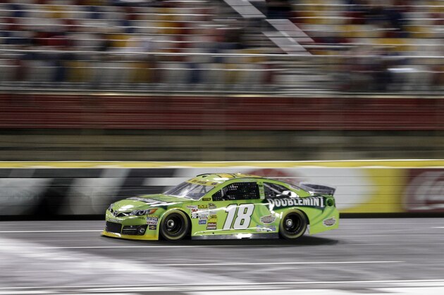 Kyle Busch drives his car qualifying for Saturday's NASCAR Bank of America Sprint Cup series auto race at Charlotte Motor Speedway in Concord, N.C., Thursday, Oct. 9, 2014. Busch won the pole position for the race with a lap of 197.390 mph. (AP Photo/Chuck Burton)