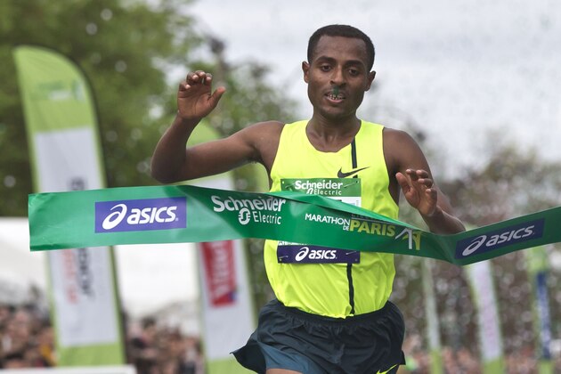 Ethiopia's runner Kenenisa Bekele crosses the finish line to win the 38th Paris Marathon,  in Paris, Sunday, April 6, 2014. Bekele completed the 42.2-kilometer race in 2 hours, 5 minutes, 3 seconds to break the race record set by Stanley Biwott of Kenya in 2012.(AP Photo/Michel Euler)