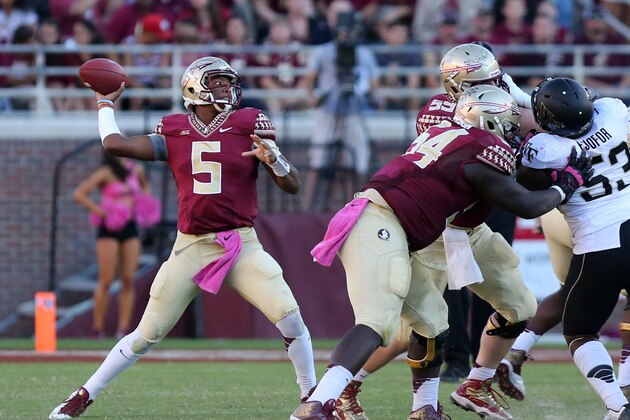 Florida State's Jameis Winston launches a pass down field against the Wake Forest defense in an NCAA college football game, Saturday Oct. 4, 2014 in Tallahassee, Fla. Florida State won the game 43-3. (AP Photo/Steve Cannon)
