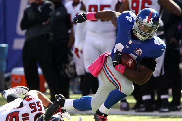 Oct 5, 2014; East Rutherford, NJ, USA; New York Giants running back Andre Williams (44) runs over Atlanta Falcons inside linebacker Paul Worrilow (55) during the second half at MetLife Stadium. The New York Giants defeated the Atlanta Falcons 30-20.Mandatory Credit: Noah K. Murray-USA TODAY Sports