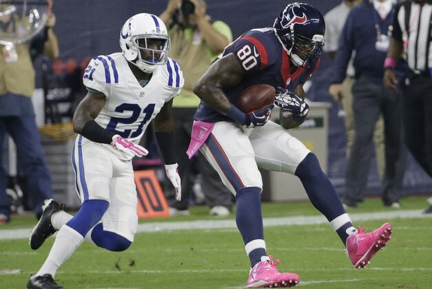 Houston Texans' Andre Johnson (80) catches a pass in front of Indianapolis Colts defender Vontae Davis (21) during the second quarter of an NFL football game, Thursday, Oct. 9, 2014, in Houston. (AP Photo/David J. Phillip)