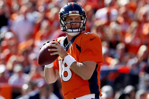 Denver Broncos quarterback Peyton Manning (18) get ready to throw his 500th career touchdown pass during the first half of an NFL football game against the Arizona Cardinals, Sunday, Oct. 5, 2014, in Denver. (AP Photo/Joe Mahoney)
