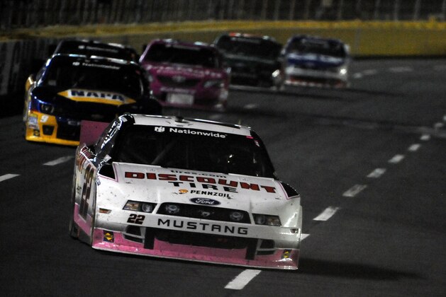 CHARLOTTE, NC - OCTOBER 10:  Brad Keselowski, driver of the #22 Discount Tire Ford, leads a pack of cars during the NASCAR Nationwide Series Drive For The Cure 300 presented by Blue Cross Blue Shield of North Carolina at Charlotte Motor Speedway on October 10, 2014 in Charlotte, North Carolina.  (Photo by Jonathan Moore/Getty Images)