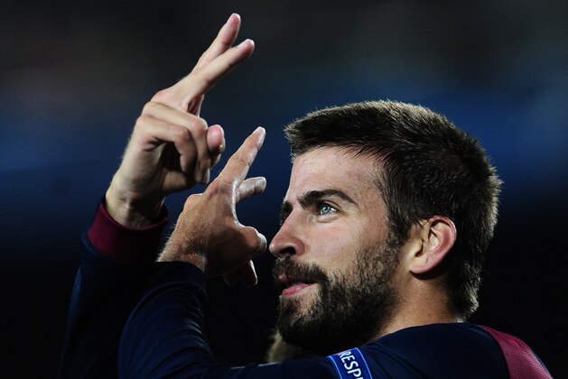 Barcelona's Gerard Pique, left, celebrates scoring against APOEL during the Champions League Group F soccer match between Barcelona and Apoel at the Camp Nou stadium in Barcelona, Spain, Wednesday, Sept. 17, 2014. (AP Photo/Manu Fernandez)