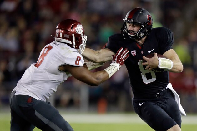 PALO ALTO, CA - OCTOBER 10:  Kevin Hogan #8 of the Stanford Cardinal straight-arms Jeremiah Allison #8 of the Washington State Cougars at Stanford Stadium on October 10, 2014 in Palo Alto, California.  (Photo by Ezra Shaw/Getty Images)