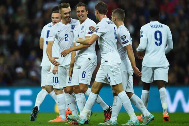 LONDON, ENGLAND - OCTOBER 09:  Phil Jagielka of England (6) celebrates with team mates Calum Chambers (2) and Jordan Henderson (4) as he scores their irst goal during the EURO 2016 Group E Qualifying match between England and San Marino at Wembley Stadium on October 9, 2014 in London, England.  (Photo by Laurence Griffiths/Getty Images)