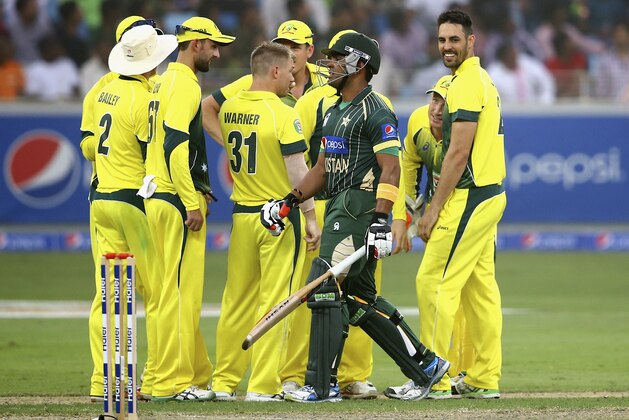 DUBAI, UNITED ARAB EMIRATES - OCTOBER 10:  Mitchell Johnson of Australia celebrates with teammates after dismissing Umar Akmal of Pakistan during the second match of the one day international series between Australia and  Pakistan at Dubai Sports City Cricket Stadium on October 10, 2014 in Dubai, United Arab Emirates.  (Photo by Francois Nel/Getty Images)