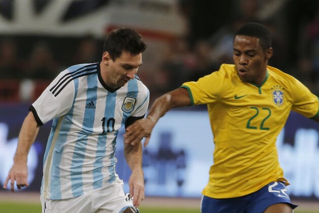 Argentina's Lionel Messi with Brazil's Elias during a Brazil vs. Argentina friendly match at the Bird's Nest National Stadium in Beijing, China, Saturday, Oct. 11, 2014. (AP Photo/Ng Han Guan)