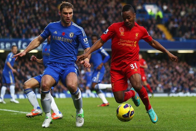 LONDON, ENGLAND - NOVEMBER 11:  Raheem Sterling of Liverpool holds off the challenge of Branislav Ivanovic of Chelsea during the Barclays Premier League match between Chelsea and Liverpool at Stamford Bridge on November 11, 2012 in London, England.  (Photo by Clive Rose/Getty Images)