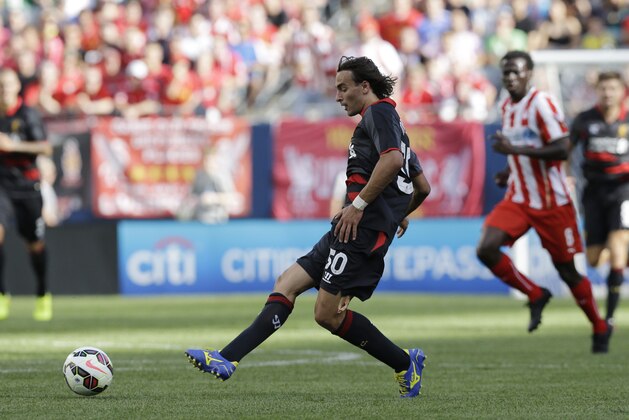 Liverpool FC midfielder Lazar Markovic (50) passes the ball against the Olympiacos during the first half of International Champions Cup soccer match in Chicago, Sunday, July 27, 2014. The Liverpool FC won 1-0. (AP Photo/Nam Y. Huh)
