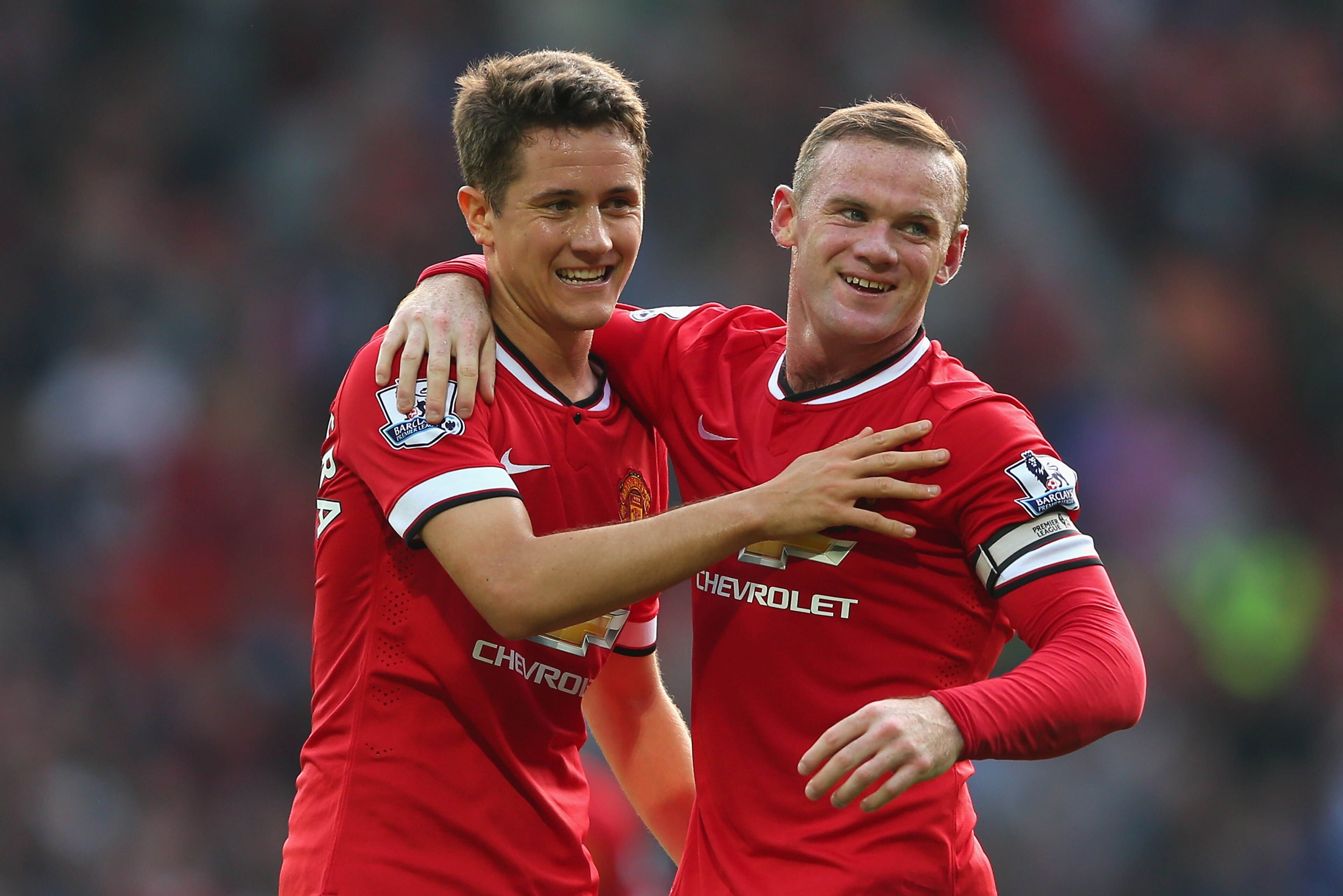 MANCHESTER, ENGLAND - SEPTEMBER 14:  Wayne Rooney of Manchester United celebrates scoring the third goal with team-mate Ander Herrera (L), during the Barclays Premier League match between Manchester United and Queens Park Rangers at Old Trafford on September 14, 2014 in Manchester, England.  (Photo by Alex Livesey/Getty Images)