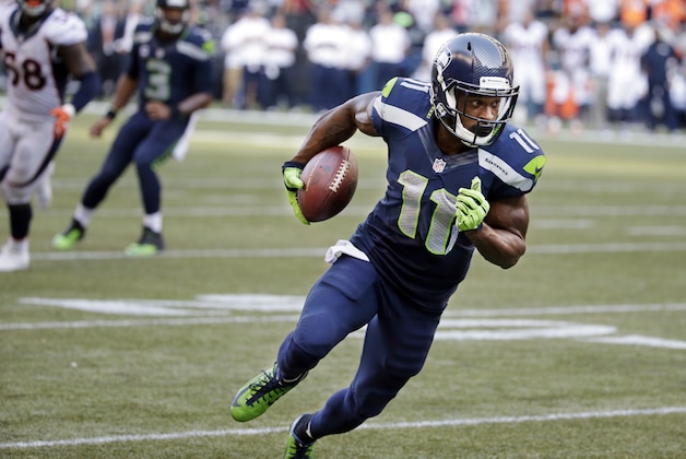 Seattle Seahawks' Percy Harvin runs with the ball after a catch in overtime against the Denver Broncos in an NFL football game, Sunday, Sept. 21, 2014, in Seattle. The Seahawks scored on the next play to win 26-20. (AP Photo/Elaine Thompson)