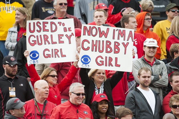 Georgia fans hold up signs in support of running backs Todd Gurley and Nick Chubb during the fourth quarter of an NCAA college football game against Missouri Saturday, Oct. 11, 2014, in Columbia, Mo. Georgia won the game 34-0. (AP Photo/L.G. Patterson)