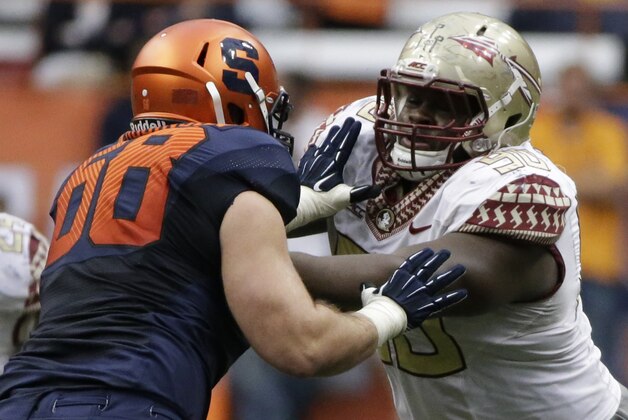 Florida State defensive tackle Eddie Goldman (90) attempts to beat Syracuse guard Nick Robinson (68) during the second half of an NCAA college football game Saturday, Oct. 11, 2014, in Syracuse, N.Y. Florida State won the game 38-20. (AP Photo/Frank Franklin II)