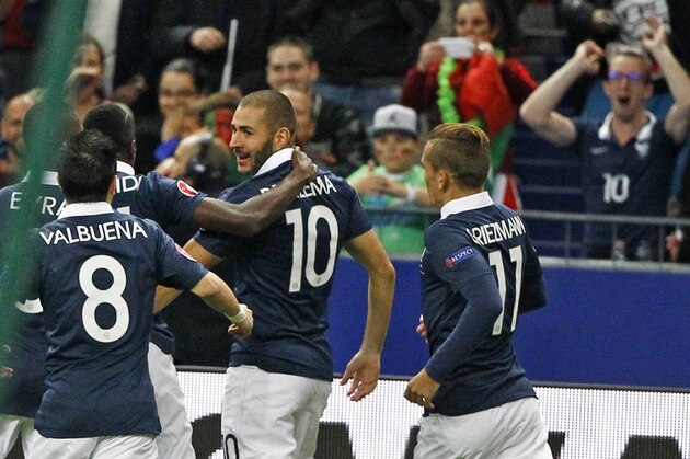 French player Karim Benzema, center, is congratulated by teammates after scoring the first goal for France during the international friendly soccer match between France and Portugal at the Stade de France stadium in Saint Denis, outside Paris, Saturday, Oct. 11, 2014. (AP Photo/Remy de la Mauviniere)