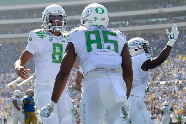PASADENA, CA - OCTOBER 11:  Marcus Mariota #8 of the Oregon Ducks celebrates the touchdown of Pharaoh Brown #85 during the first half against the UCLA Bruins at Rose Bowl on October 11, 2014 in Pasadena, California.  (Photo by Harry How/Getty Images)
