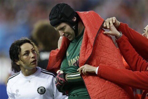 Chelsea goalkeeper Petr Cech is covered by a blanket as he leaves the pitch following an injury during the Champions League semifinal first leg soccer match between Atletico Madrid and Chelsea at the Vicente Calderon stadium in Madrid, Spain, Tuesday, April 22, 2014 .(AP Photo/Paul White)