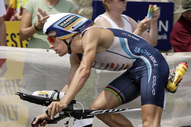Competitor  Sebastian Kienle, of Germany, returns to Kailua-Kona from a 112-mile bike ride before beginning the 26.2 mile marathon in the Ironman World Championship Triathlon, Saturday, Oct. 12, 2013, in Kailua-Kona, Hawaii. (AP Photo/Chris Stewart)