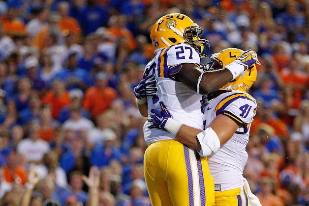 GAINESVILLE, FL - OCTOBER 11: Kenny Hilliard #27 of the LSU Tigers is congradulated by teammate Travis Dickson #41 after scoring a touchdown during the second quarter of the game against the Florida Gators at Ben Hill Griffin Stadium on October 11, 2014 in Gainesville, Florida.  (Photo by Rob Foldy/Getty Images)