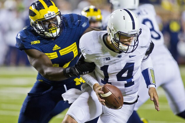 Michigan defensive end Frank Clark (57) sacks Penn State quarterback Christian Hackenberg (14) in the fourth quarter of an NCAA college football game in Ann Arbor, Mich., Saturday, Oct. 11, 2014. Michigan won 18-13. (AP Photo/Tony Ding)