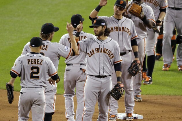 San Francisco Giants players celebrate their 3-0 win in Game 1 of the National League baseball championship series against the St. Louis Cardinals Saturday, Oct. 11, 2014, in St. Louis. (AP Photo/Eric Gay)
