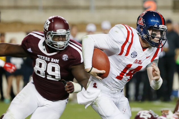 COLLEGE STATION, TX - OCTOBER 11:  Bo Wallace #14 of the Mississippi Rebels runs past Ivan Robinson #89 of the Texas A&M Aggies in the fourth quarterduring their game at Kyle Field on October 11, 2014 in College Station, Texas.  (Photo by Scott Halleran/Getty Images)