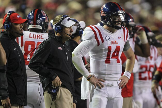 Oct 11, 2014; College Station, TX, USA; Mississippi Rebels head coach Hugh Freeze stands on the sideline with quarterback Bo Wallace (14) during the third quarter against the Texas A&M Aggies at Kyle Field. Mandatory Credit: Troy Taormina-USA TODAY Sports