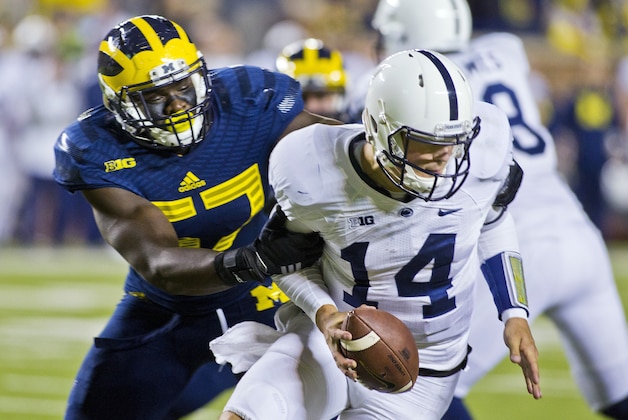 Michigan defensive end Frank Clark (57) sacks Penn State quarterback Christian Hackenberg (14) in the fourth quarter of an NCAA college football game in Ann Arbor, Mich., Saturday, Oct. 11, 2014. Michigan won 18-13. (AP Photo/Tony Ding)