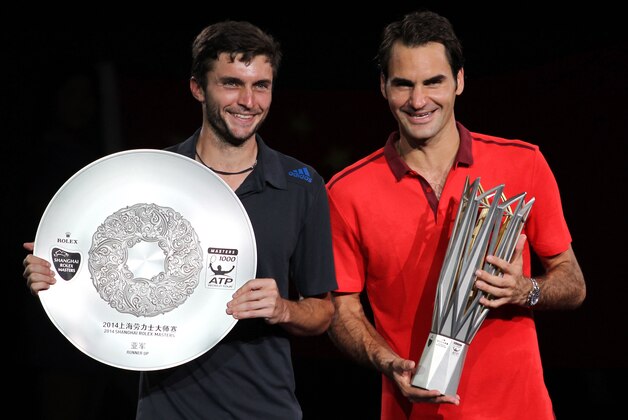 SHANGHAI, CHINA - OCTOBER 12: Shanghai Rolex Masters champion Roger Federer of Switzerland and runner-up Gilles Simon of France pose for photos with their trophies after the final during the day 8 of the Shanghai Rolex Masters at the Qi Zhong Tennis Center on October 12, 2014 in Shanghai, China. (Photo by Zhong Zhi/Getty Images)