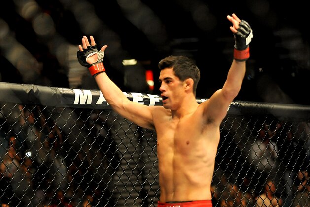 Sep 27, 2014; Las Vegas, NV, USA; Dominick Cruz celebrates his knockout victory in the first round over Takeya Mizugaki during a bantamweight fight in UFC 178 at MGM Grand Garden Arena. Mandatory Credit: Stephen R. Sylvanie-USA TODAY Sports