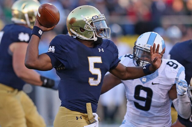 SOUTH BEND, IN - OCTOBER 11: Everett Golson #5 of the Notre Dame Fighting Irish passes under pressure from Travis Hughes #9 of the North Carolina Tar Heels at Notre Dame Stadium on October 11, 2014 in South Bend, Indiana. Notre Dame defeated North Carolina 50-43. (Photo by Jonathan Daniel/Getty Images)