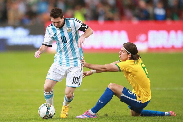 BEIJING, CHINA - OCTOBER 11:  Filipe Luis of Brazil (Right) competes the ball with Lionel Messi of Argentina (Left) during Super Clasico de las Americas between Argentina and Brazil at Beijing National Stadium on October 11, 2014 in Beijing, China.  (Photo by Feng Li/Getty Images)