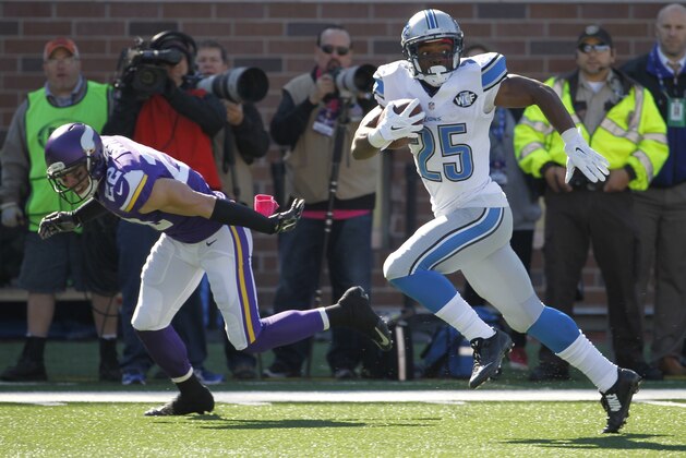 Detroit Lions running back Theo Riddick is chased by Minnesota Vikings free safety Harrison Smith during the first half of an NFL football game Sunday, Oct. 12, 2014, in Minneapolis. (AP Photo/Ann Heisenfelt)