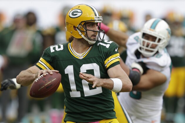 Green Bay Packers quarterback Aaron Rodgers (12) looks to pass during the first half of an NFL football game against the Miami Dolphins, Sunday, Oct. 12, 2014, in Miami Gardens, Fla. (AP Photo/Wilfredo Lee)