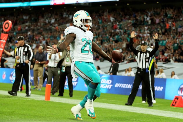 LONDON, ENGLAND - SEPTEMBER 28:  Lamar Miller #26 of the Miami Dolphins scores his team's second touchdown on a nine yard rush during the NFL match between the Oakland Raiders and the Miami Dolphins at Wembley Stadium on September 28, 2014 in London, England.  (Photo by Ben Hoskins/Getty Images)