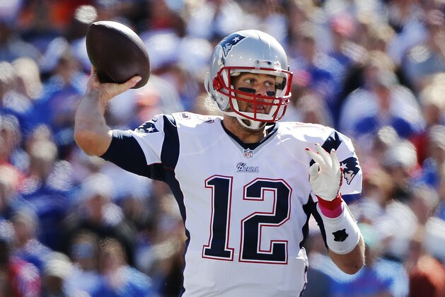 New England Patriots' Tom Brady (12) throws a pass during the first half of an NFL football game against the Buffalo Bills Sunday, Oct. 12, 2014, in Orchard Park, N.Y. (AP Photo/Mike Groll)