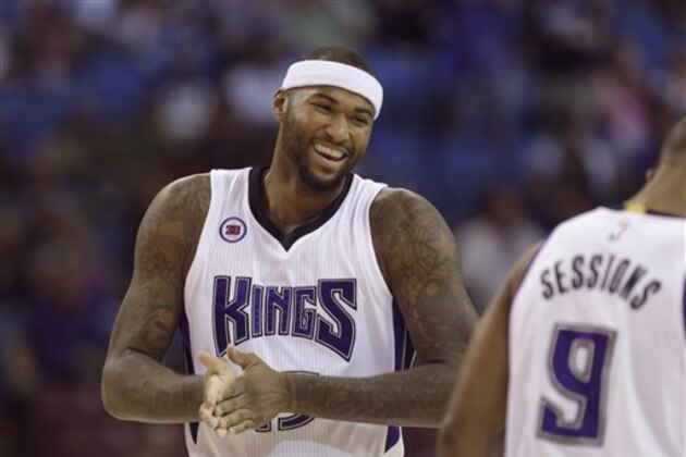 Sacramento Kings center DeMarcus Cousins laughs as he walks downcourt during an NBA preseason game against the Toronto Raptors in Sacramento, Calif., Tuesday, Oct. 7, 2014.  The Kings won 113-106. (AP Photo/Rich Pedroncelli)