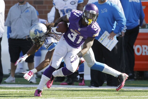 Minnesota Vikings running back Jerick McKinnon (31) pulls away from Detroit Lions cornerback Rashean Mathis (31) during the second half of an NFL football game Sunday, Oct. 12, 2014, in Minneapolis. (AP Photo/Ann Heisenfelt)