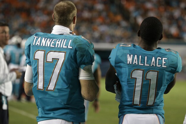 Miami Dolphins quarterback Ryan Tannehill (17) and  wide receiver Mike Wallace (11) watch the game during the second half of an NFL preseason football game against the Dallas Cowboys, Saturday, Aug. 23, 2014 in Miami Gardens, Fla. (AP Photo/Lynne Sladky)