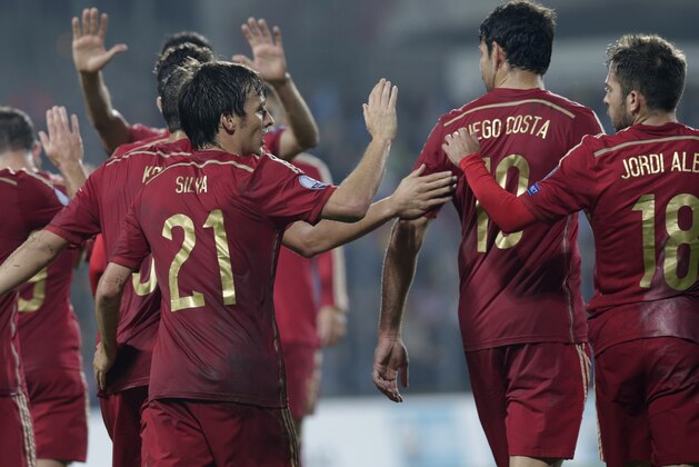 Spain's David Jimenez Silva, left, is congratulated by team members after he scored during the Euro 2016 qualifying match in group C between Luxembourg and Spain at the Josy Barthel stadium, in Luxembourg City, Luxembourg, Sunday, Oct. 12, 2014. (AP Photo/Yves Logghe)