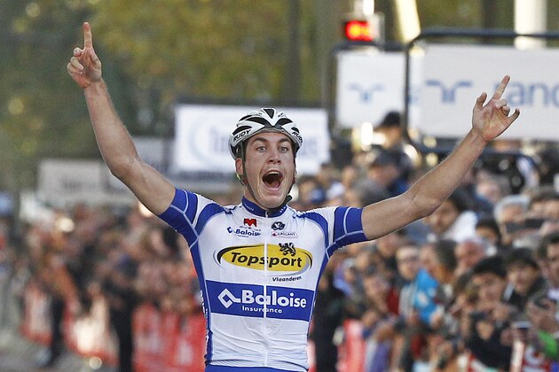 Belgium's Jelle Wallays raises his arms in victory, as he crosses the finish line to win the Paris-Tours classic cycling race, in Tours, western France, Sunday Oct. 12, 2014. France's Thomas Voeckler takes the second place. (AP Photo/Remy de la Mauviniere)