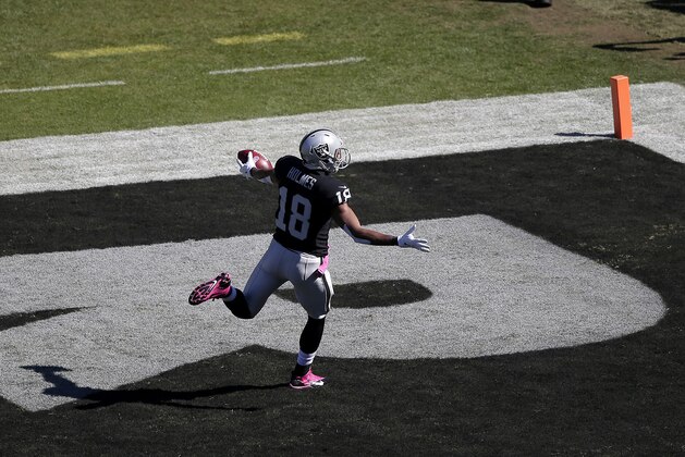Oakland Raiders wide receiver Andre Holmes (18) celebrates after catching a 77-yard touchdown against the San Diego Chargers during the first quarter of an NFL football game in Oakland, Calif., Sunday, Oct. 12, 2014. (AP Photo/Marcio Jose Sanchez)