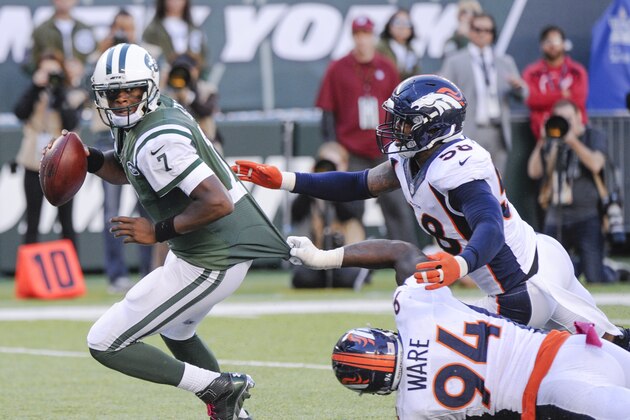 New York Jets quarterback Geno Smith (7) tries to avoid a sack by Denver Broncos defensive end DeMarcus Ware (94) and outside linebacker Von Miller (58) during the fourth quarter of an NFL football game, Sunday, Oct. 12, 2014, in East Rutherford, N.J. (AP Photo/Bill Kostroun)