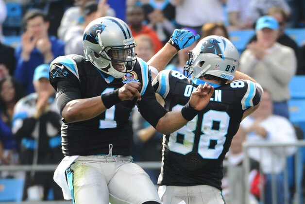 Dec 9, 2012; Charlotte, NC, USA; Carolina Panthers tight end Greg Olsen (88) celebrates his touchdown catch with quarterback Cam Newton (1) in the first quarter at Bank of America Stadium. Mandatory Credit: Bob Donnan-USA TODAY Sports